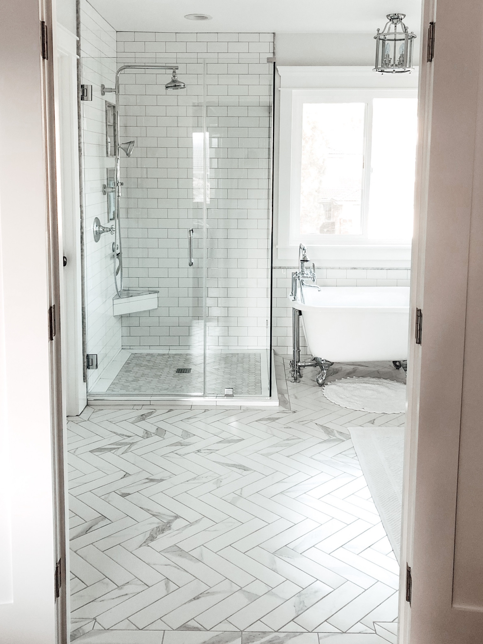 White and grey bathroom with polished chrome fixtures.

www.livingbarelyblonde.com

#bathroomfixtures #polishedchromefixtures #whitebathroom #freestandingtub #bathroommirror

#LTKstyletip #LTKhome #LTKFind