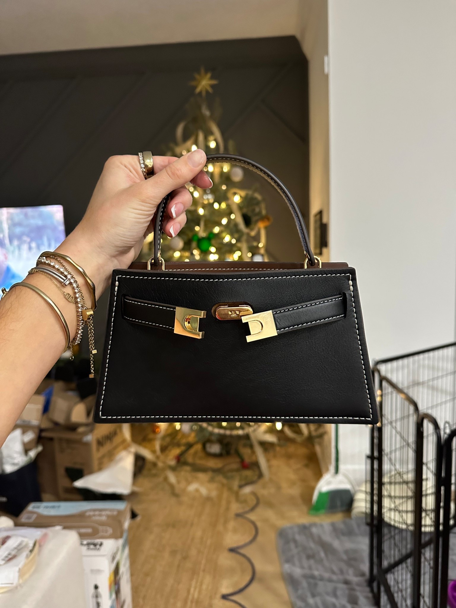 Tory Burch. The Mini Lee Radziwill Top-Handle Bag is beautifully crafted in a luxurious mix of leather and suede. Carry it in hand or wear crossbody with the removable strap. The structured shape is finished with our signature T-lock belt closure. The collection is named for Lee Radziwill, who was fearlessly unique.   

#LTKGiftGuide #LTKootd #LTKSeasonal