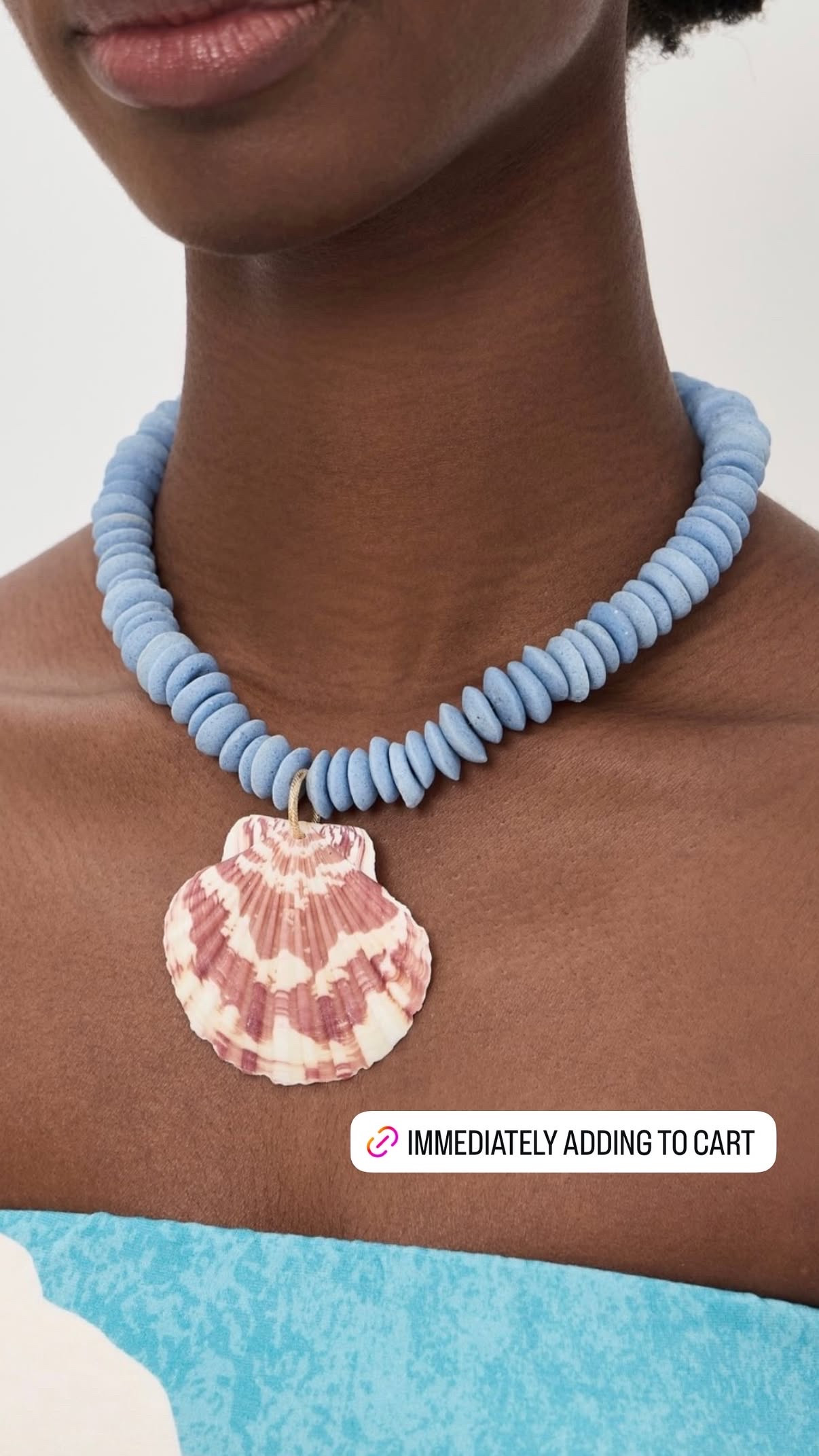 The necklace I immediately added to cart and I'm not apologizing for it.
Logan Tay's Carolina Blue Shell Necklace is powder blue disc beads with a real scallop shell pendant on a gold toggle — it's the summer jewelry piece that looks like you found it at a market in Brazil and paid way more than $89 for it. The blue against a tan, a white dress, or a simple swimsuit is the combination that makes people stop and ask where you got it.
One pendant, one color, zero overthinking. That's the whole brief for summer jewelry and this nails it. 

 