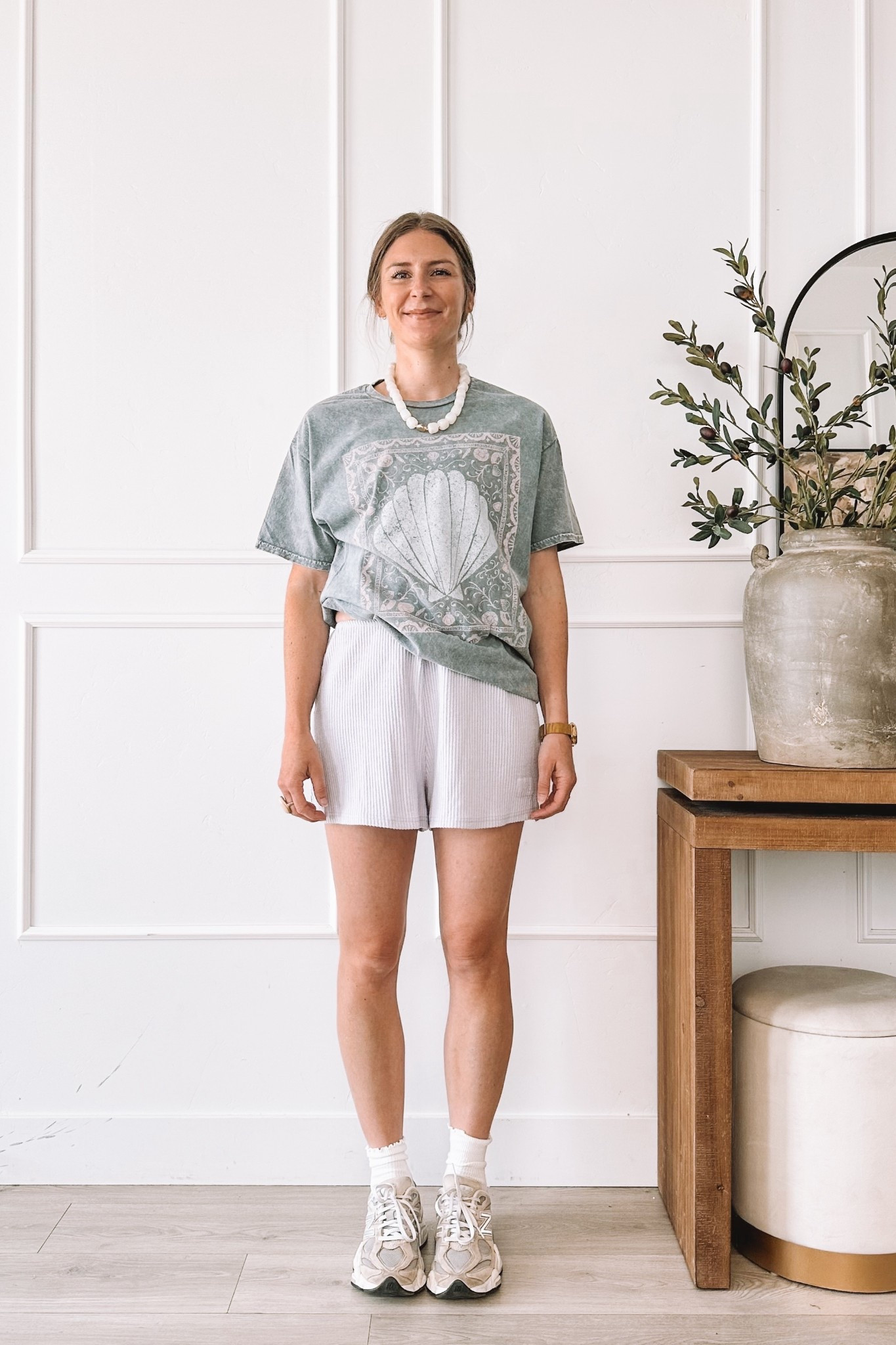 Sage green shell graphic tee with white ribbed shorts, New Balance sneakers and a pearl necklace. Wearing a large in the tee. I am 5’8” and typically a small so size up at least two sizes for this look. All pieces linked here.

#LTKgrwm #LTKmomlife #LTKootd