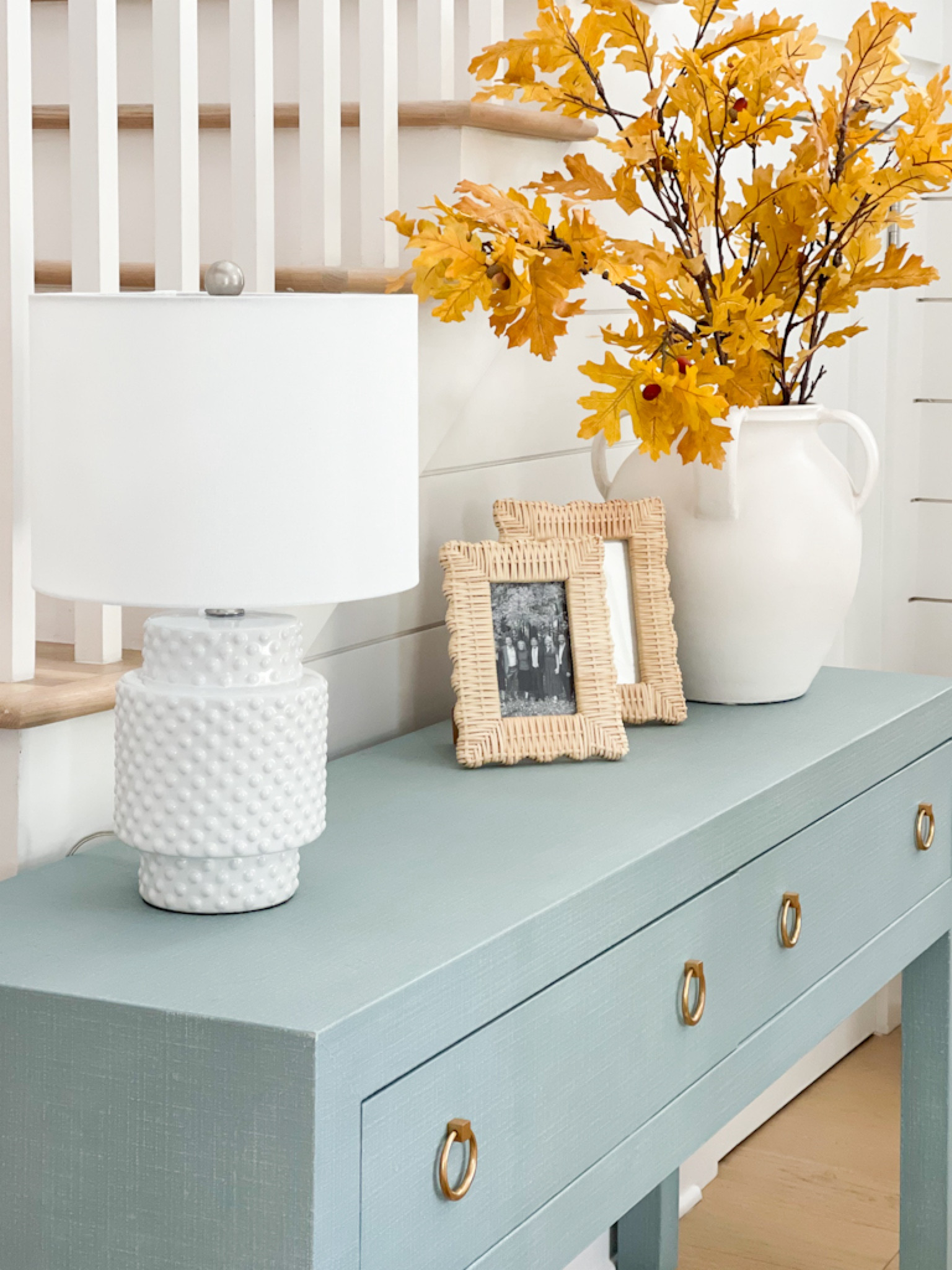 Our fall entryway last year with our blue linen console table, hobnail lamp (designer look for less), scalloped wicker frames, and a white ceramic vase filled with golden oak leaves. Loving the blue and yellow color combo for fall!
.
#ltkhome #ltkseasonal #ltkfindsunder50 #ltkfindsunder100 #ltkstyletip #ltkover40 #ltksalealert

#LTKHome #LTKSeasonal #LTKSaleAlert