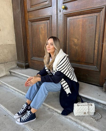 Blue Spring Day Outfit, styling a navy blue trench coat with blue mom jeans, featuring a black and white stripe jumper draped over the shoulders, black platform chunky converse and Chanel bag in white

#LTKstyletip #LTKSpringSale #LTKSeasonal