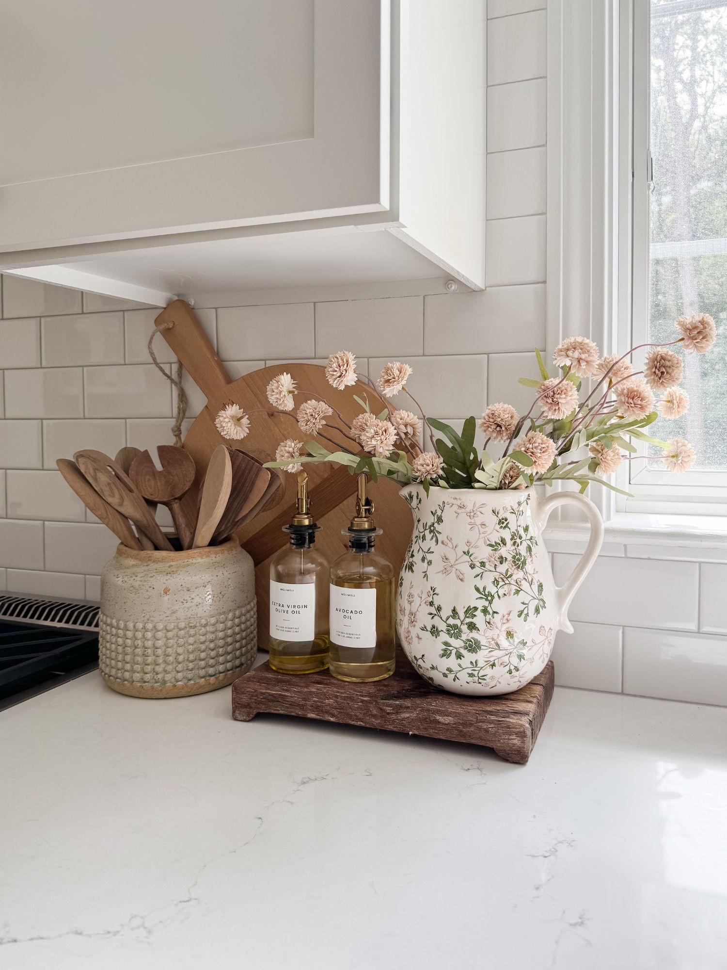 Simple countertop styling with wood accents and glass bottles creates an elevated everyday kitchen moment. coastal kitchen decor, kitchen styling ideas, oil and vinegar bottles, neutral home decor, designer inspired kitchen, coastal interiors, natural textures, kitchen inspiration, sherricalnanhome

#LTKHome