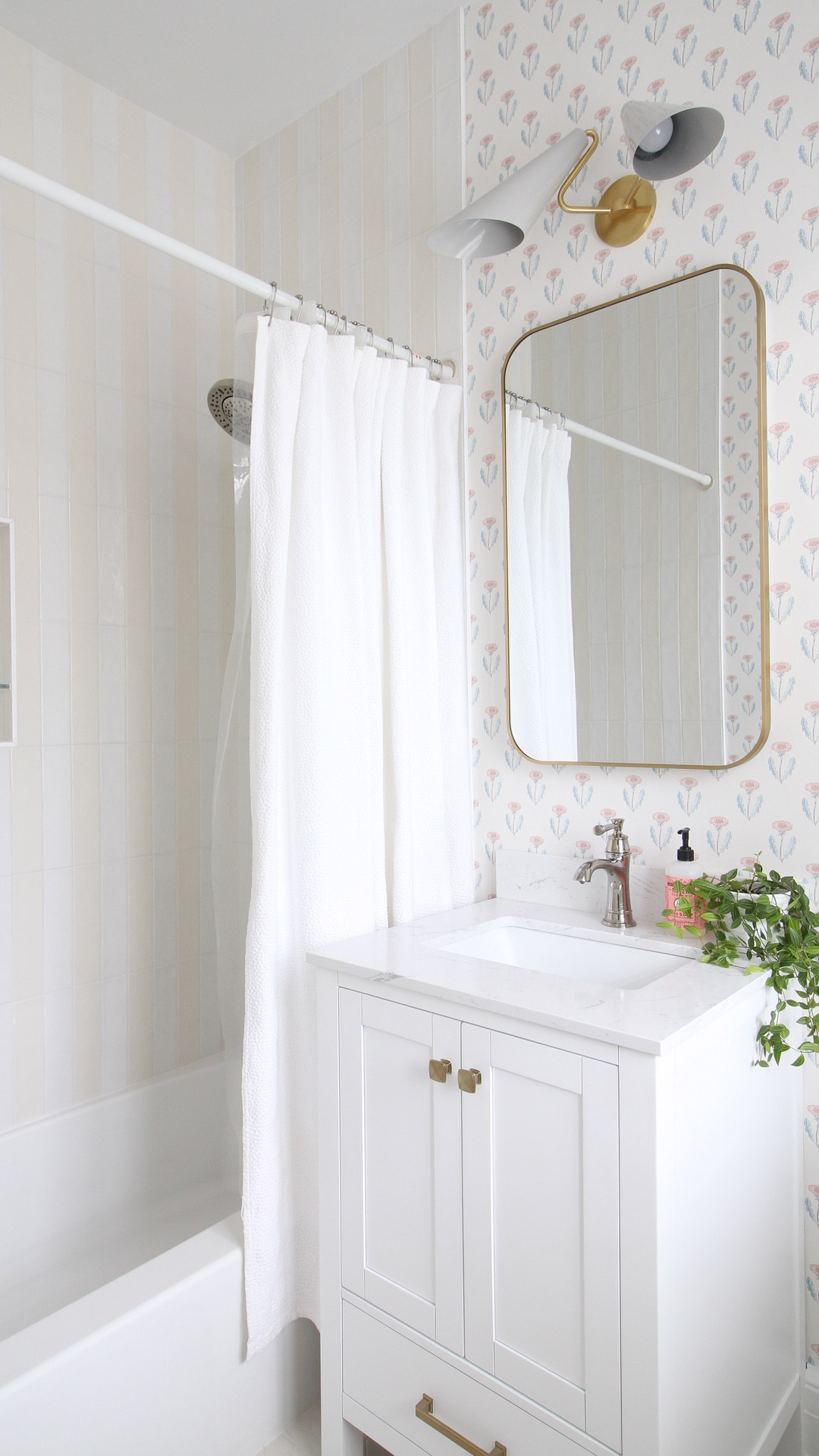 I love a good challenge. 🤓 This bathroom in our new-to-us 1920s home was in dire need of a total renovation. It’s hard to believe this was a Jack and Jill style with two doors entering into a 5‘ x 7.5‘ space! To make it more functional we closed off a door and moved the vanity and shower plumbing to be in line with the toilet so everything was in a nice row. I also wanted to make sure it had lots of personality, so I designed it with a vertical ivory and white striped tile and added a floral block print wallpaper. Needless to say, I am in love with this for both its function and modern cottage style! I am so excited for my daughter to use it for many years to come. 

#LTKHome
