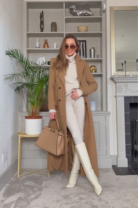 - tan long coat
- cream roll neck knit
- ivory knee high boots
