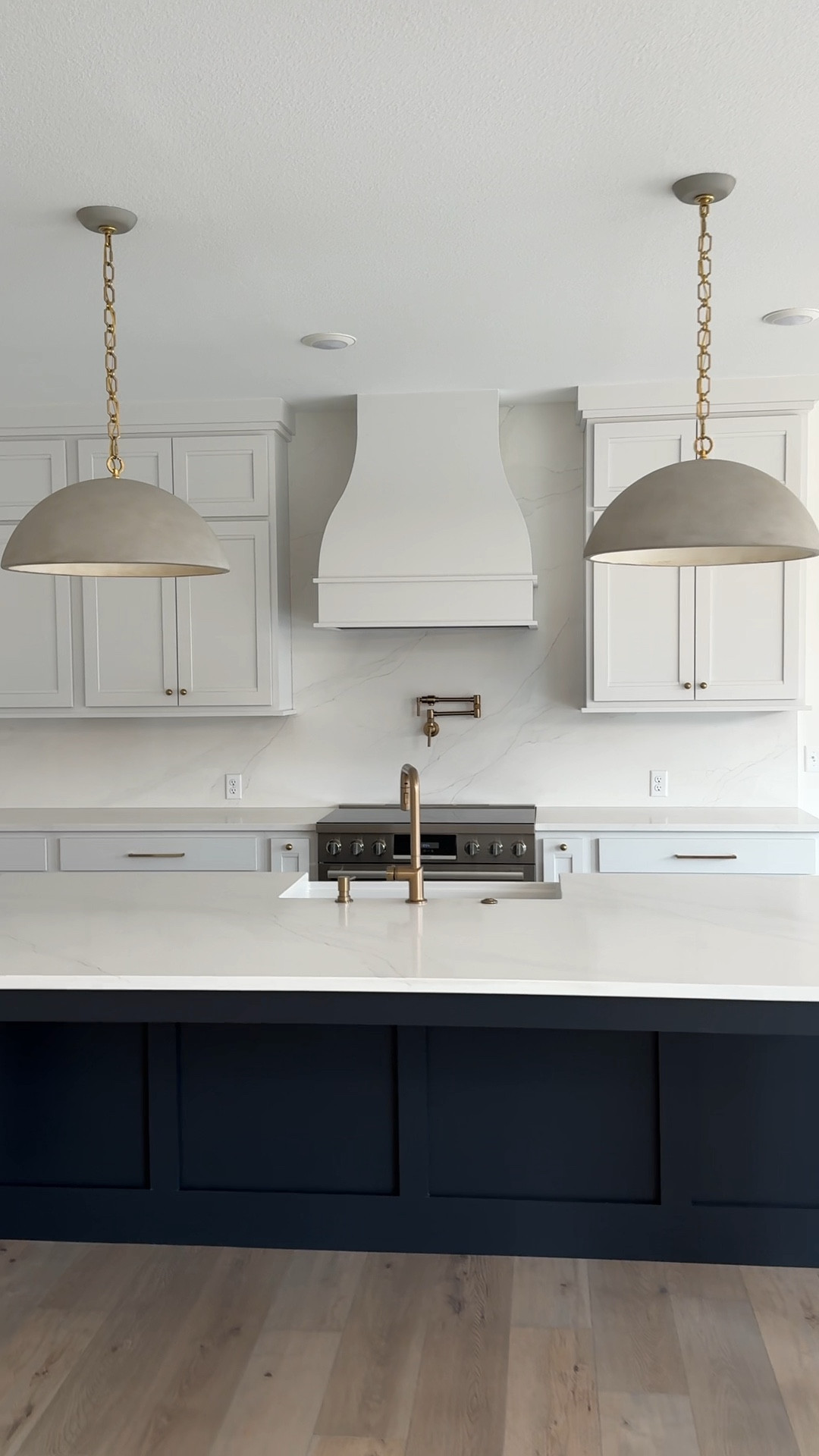 Simple and clean lines in this transitional kitchen!

New build
Kitchen design
Concrete pendants 
White and navyy

#LTKMostLoved #LTKhome