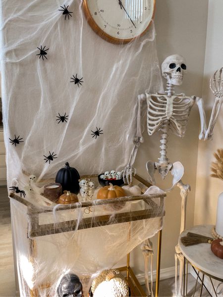 Halloween bar cart styling 
Halloween decor
Skeleton 
Skulls
Spider web
Ceramic pumpkins 


#LTKhome #LTKHalloween