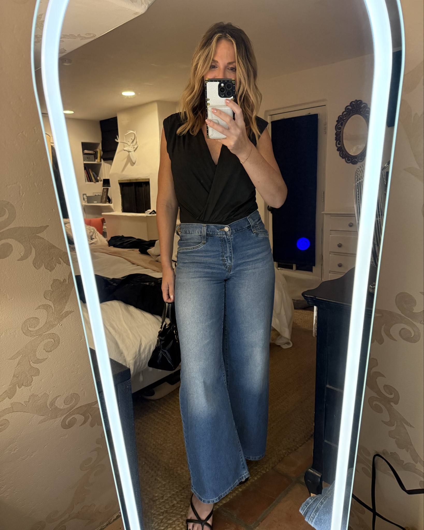 Obsessed with winter-to-spring date night outfits that feel equal parts casual, chic, and a little bit sexy 🖤✨

This black sleeveless V-neck ruched bodysuit is SO flattering — the ruching smooths everything out and gives that sculpted, snatched look without feeling tight or uncomfortable. It’s the perfect elevated basic for layering season.

Paired with my @Levi's  Mid Rise 94 Loose Baggy Jeans (the BEST relaxed wide leg winter denim 🙌). These are that effortless, cool-girl silhouette — mid rise, vintage inspired, relaxed through the leg, and insanely flattering with a fitted top.

I finished the look with black kitten heels for that polished but still easy vibe — perfect for warmer winter days or early spring date nights. You could also throw on a black leather jacket, style it with a sleek pencil skirt, or dress it up with tailored slacks for a more elevated evening look.

Linking everything here for you 🤍
Size reference: wearing a medium in the bodysuit. I’m 5’7” for reference and usually wear a small in tops and medium in bottoms  
Levi’s have no stretch but run tts 









winter date night outfits, casual sexy outfit ideas, black bodysuit outfit, ruched bodysuit styling, Levi’s 94 loose baggy jeans, wide leg jeans outfit, mid rise denim, spring date night look, elevated basics, minimalist chic outfit, girls night outfit idea, classic black heels outfit

Linking everything here for you 🤍
Size reference: wearing a medium in the bodysuit.

#LTKootd #LTKOver40 #LTKgrwm