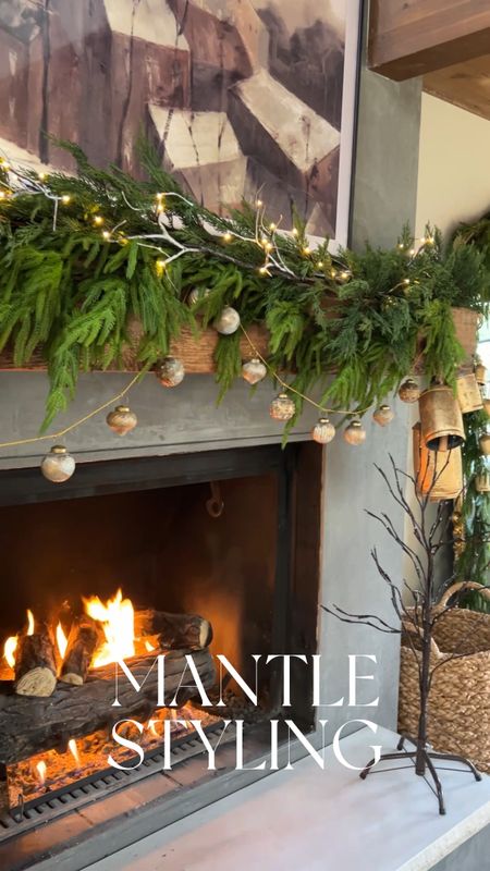 Family room fireplace mantle styling using pine and cypress garland and some Amazon holiday finds! Layered garland creates a more dramatic look! And I love this lit up branch garland from Amazon 

#LTKHoliday #LTKSeasonal #LTKhome