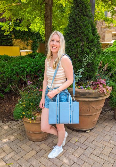 Easy everyday casual outfit. Beige and white striped sweater tank top, medium wash high waist denim shorts, white sneakers, blue Coach tote bag. Amazon fasion, Amazon style, Coach purse, Coach bag, detachable strap, work bag.

#LTKfindsunder50 #LTKitbag #LTKSeasonal