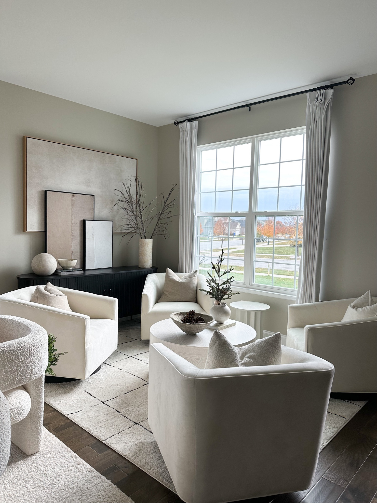 modern sitting room, swivel chairs, framed art, round coffee table 

#LTKsalealert #LTKhome #LTKCyberWeek