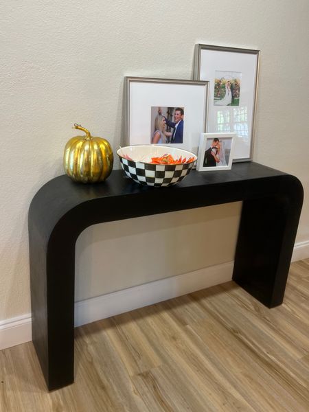 Entryway table just off our living room is ready for Halloween - Mackenzie Childs extra large bowl filled with candy for trick or treaters and a subtle gold pumpkin for decor on our horseshoe cb2 console table 

#LTKSeasonal #LTKhome #LTKHalloween