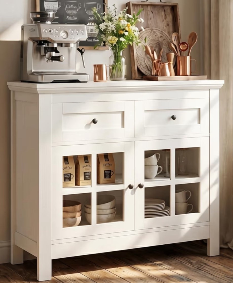Vintage white buffet cabinet with that cozy farmhouse kitchen feel that makes a space look warmer and more collected. ☕️🌿🐄 Perfect for a coffee bar, dining room, kitchen storage, entryway, living room, or hosting setup when you want extra storage that still feels decorative. The glass display doors, drawers, adjustable shelves, and vintage finish give it that rustic farmhouse look while still working beautifully in modern spaces. 

Add this cabinet if your home needs a pretty storage piece for coffee corners, dishes, linens, or everyday hosting essentials. 🪿✨

#LTKOver40 #LTKHome #LTKfoodie