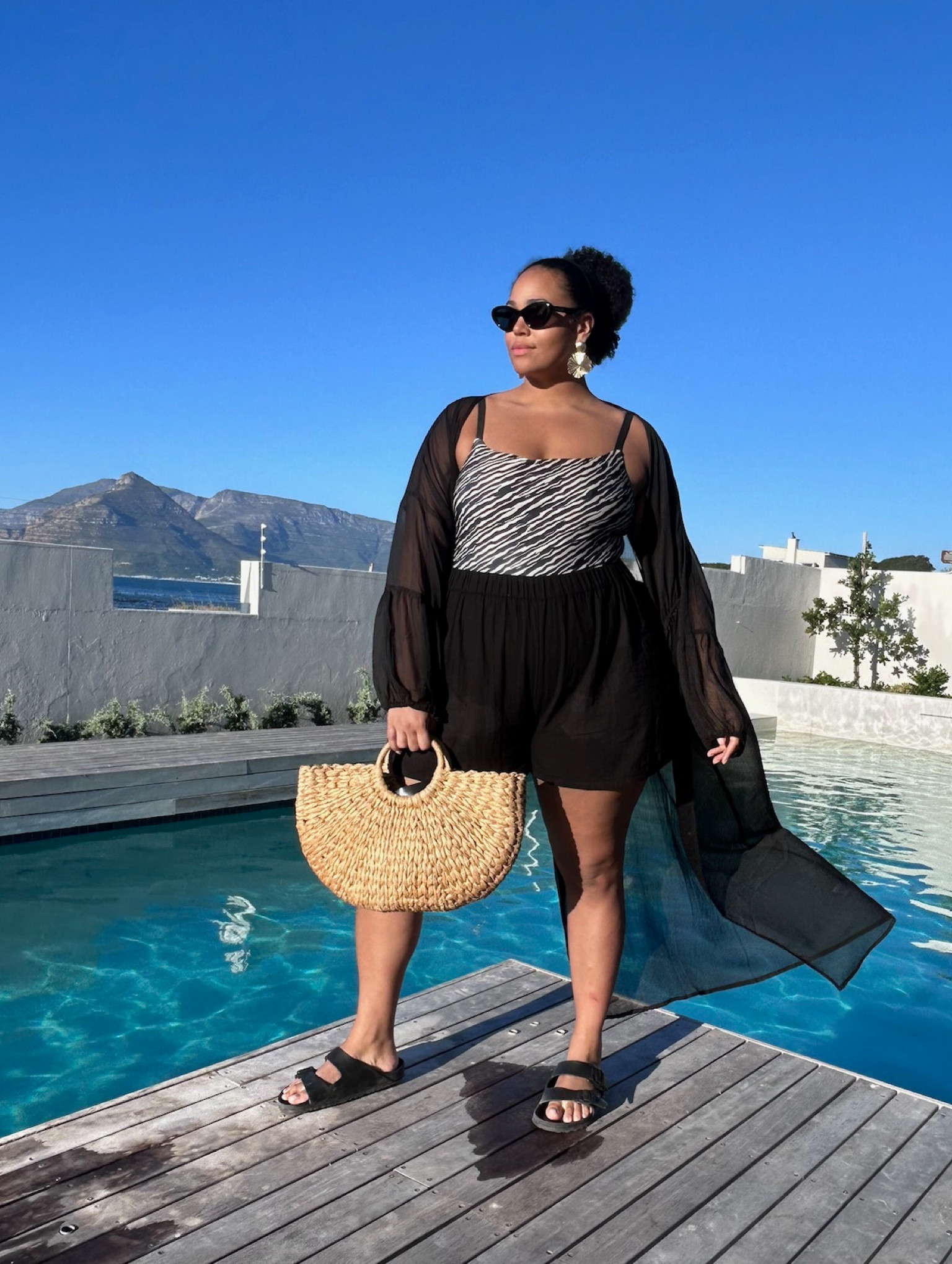Pool party throwback from my trip to South Africa! Can’t wait to get back to Cape Town soon - keep your eyes peeled as I have some exciting updates!

I felt so comfy, yet glam ✨ by the pool in this outfit - let me break it down for you…

My sunnies are Gucci - they have a little discount on atm, but for a more affordable option I have also tagged a similar pair from Le Spec for those who love the cat eye look! 😎

These shorts are so comfy, textured fabric and a light loose fit. They come in both the standard and Curve ranges from ASOS - I’ve tagged both for you. This gorgeous Zebra print Swimsuit I’m wearing under the shorts is from Hunkermoller and runs up to a Size 18 🦓

This beach kimono made this pool outfit that little extra glam, it gives such a great twist to an outfit, also meaning you can easily skip from pool to lunch and feel put together - this one is from South Beach on ASOS 🌊

I have tagged similar versions of my bag and earrings, and of course, the vegan rubber Birkenstocks are tagged for you - super comfy and a classic look which match with so many looks while on holiday 🏖️

Don’t forget all my profits this month go to the Red Cross Israel & Occupied Palestine Territory Appeal 🌎

#LTKplussize #LTKswim #LTKtravel