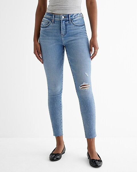 Mid Rise Medium Wash Ripped Raw Hem Skinny Jeans | Express
