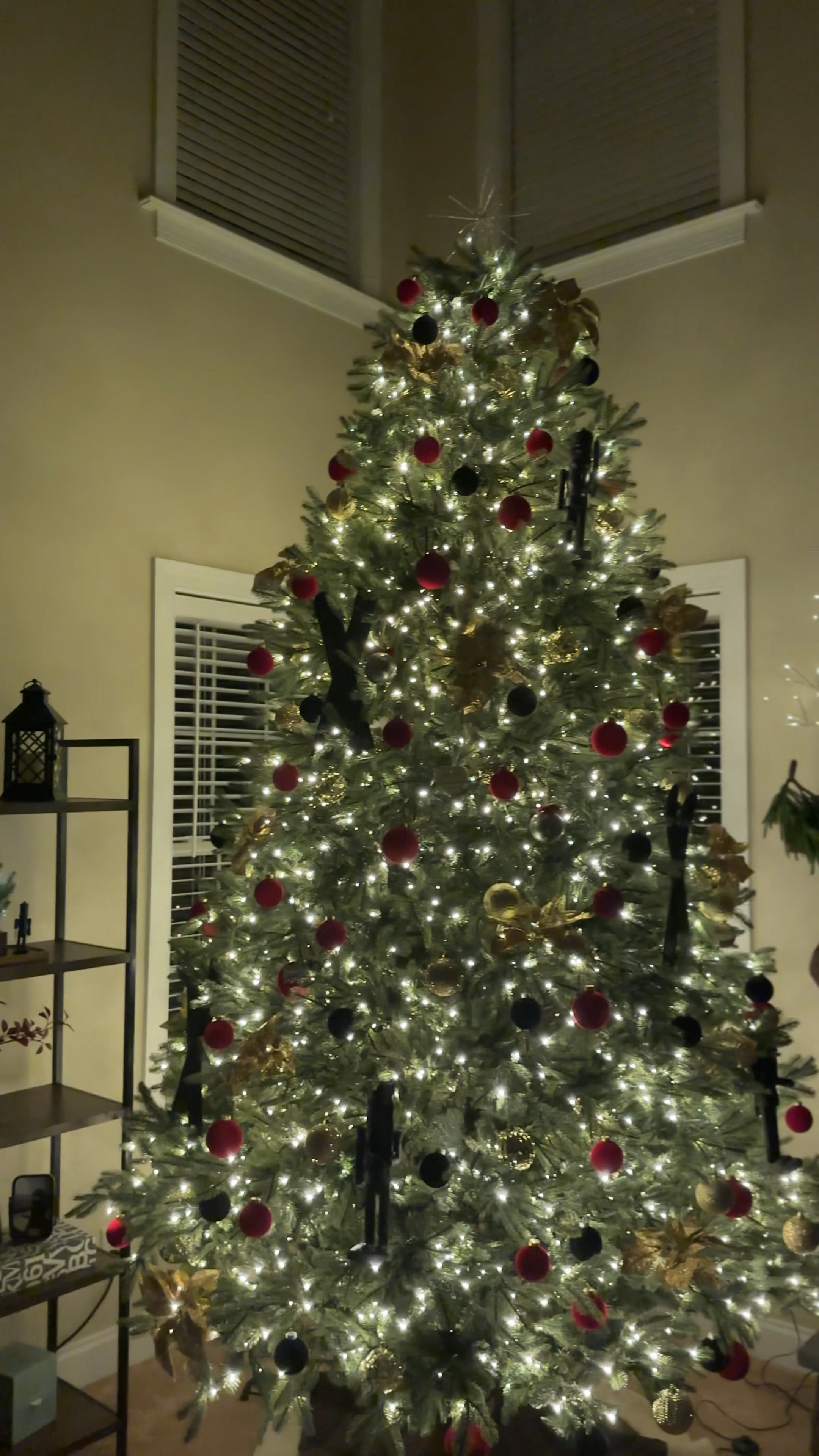 Main living room tree details ✨🎄 I wasn't planning to have this 12 foot pre-lit up this year, so we quickly pulled together some ornaments without much planning! 

I used wooden skis and nutcrackers that I spray painted black to fill in some large areas. From there, I used gold poinsettia clips throughout and filled in the remained with red and black flocked velvet ornaments. 

I'm happy for how it came together but have some ideas for how to make it better next year 😊

Christmas tree decor // Christmas tree inspo // large Christmas tree // flocked ornaments // velvet balls // modern nutcracker // Christmas DIY

#LTKVideo #LTKhome #LTKHoliday