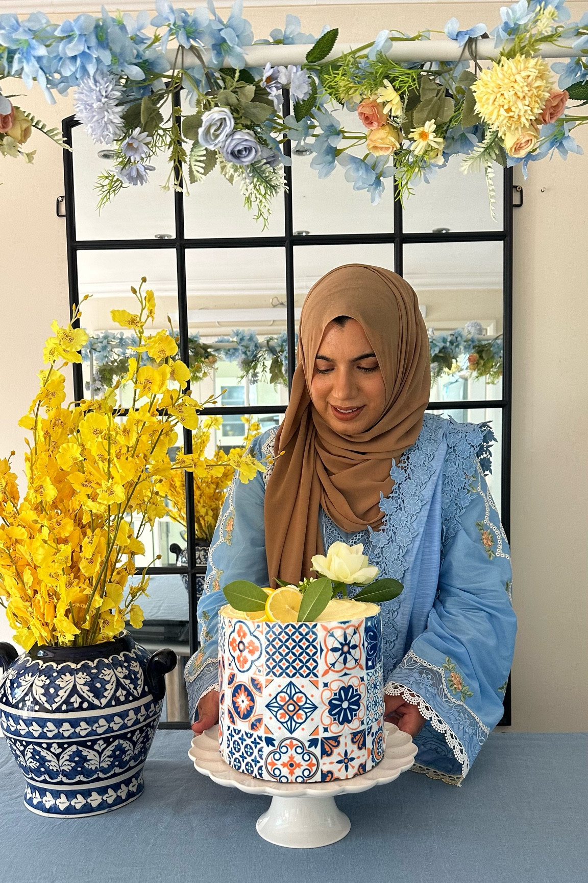Eid Decor 
1- Mediterranean pattern tile blues Edible Printed Icing Cake topper on a Lemon Cake 
2- Blue pottery with Yellow contrast flowers 
3- table top rail with flower decor 

#LTKhome #LTKFind #LTKeurope