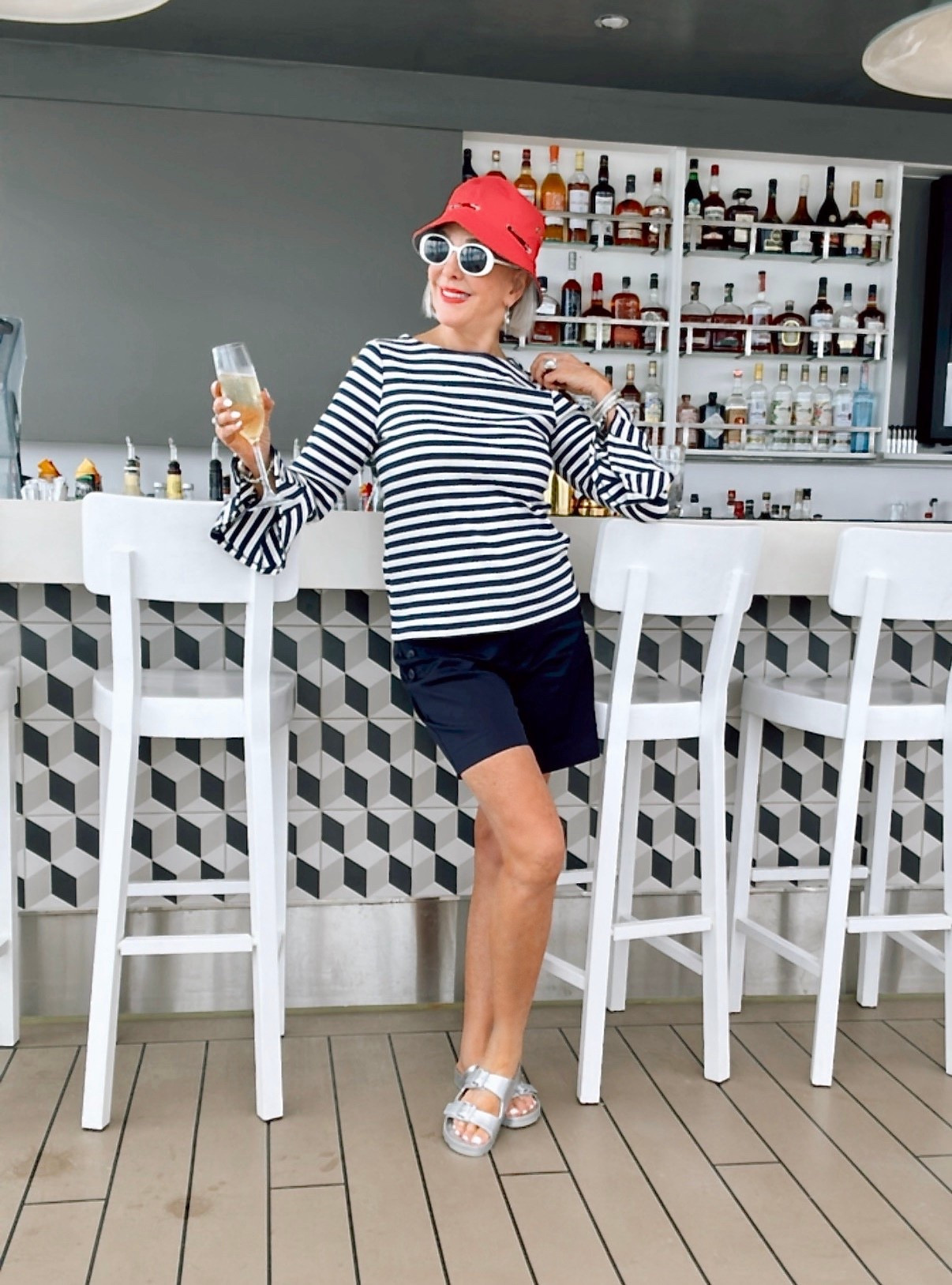 Stripe rib knot bell sleeve top
Navy stretch twill 7” shirts. Red bucket hat and white oval sunglasses 
I war a size 0 in Chico’s unique sizing 

#LTKSaleAlert #LTKActive #LTKOver40