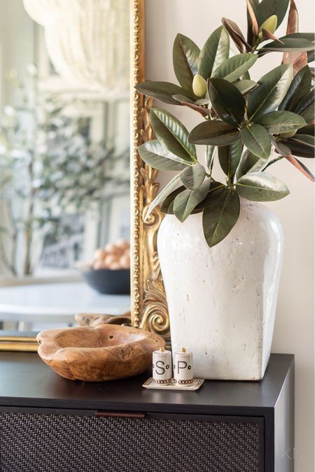 This large white stoneware vase filled with three faux magnolia branches is at home all year long on my black cane sideboard in the breakfast nook. home decor sideboard styling faux magnolia stem dining room decor faux floral#LTKfindsunder50 #LTKhome

#LTKSeasonal