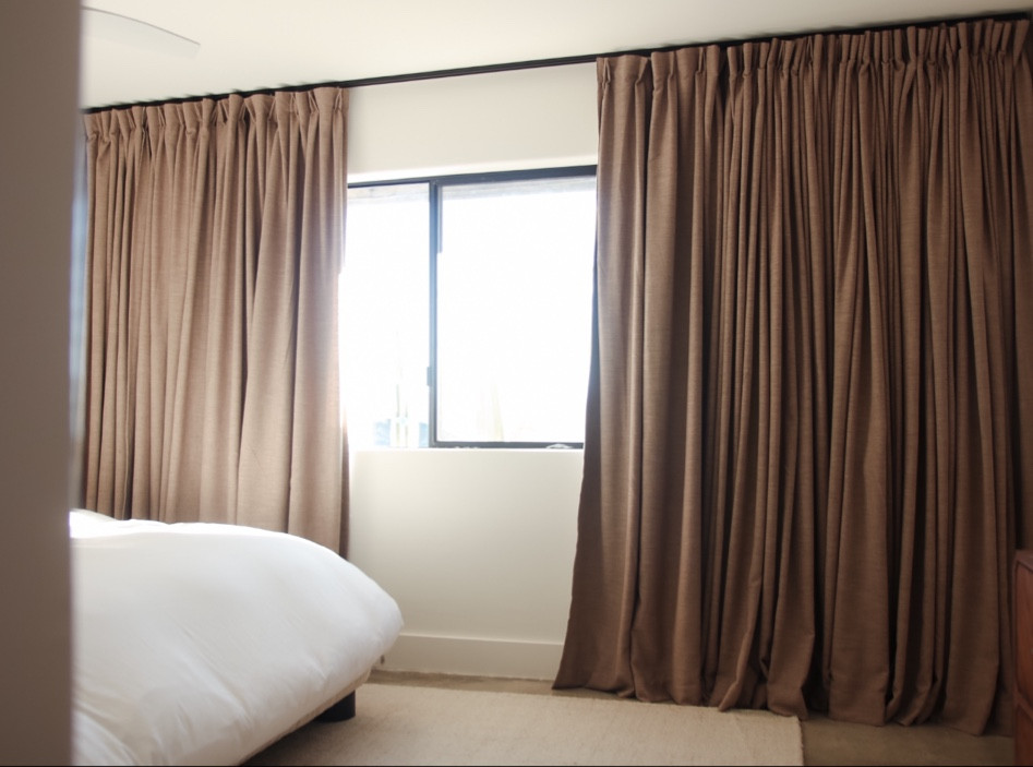 Want affordable custom curtains!? I have found the BEST solution for beautiful custom drapes at a fraction of the cost of what you’d get anywhere else. I would highly recommend ordering the fabric swatch sample booklet before ordering because there are so many variations of colors that you’re going to want to see them in your space. I initially ordered these in light Khaki (with the tailor pleat) but had to reorder them :( in Taupe Grey because the original color pulled a bit more yellow in this south facing room. I also have them in Burlywood Birch in my dining room and I LOVE that color! They are custom, so you can’t return them if the color is off but they are so affordable. Another tip, we ordered the blackout lining and while it’s amazing, they are VERY heavy. So make sure you’re using all of the support possible (preferably using studs) when you’re hanging your new curtains. We also ordered this curtain rod to the back of our two front panels to help us close the curtains without having to touch them with our hands all of the time! Overall, these custom curtains give this place a hotel vibe and our sleep is top notch thanks to the blackout lining! 

#LTKstyletip #LTKfindsunder100 #LTKhome