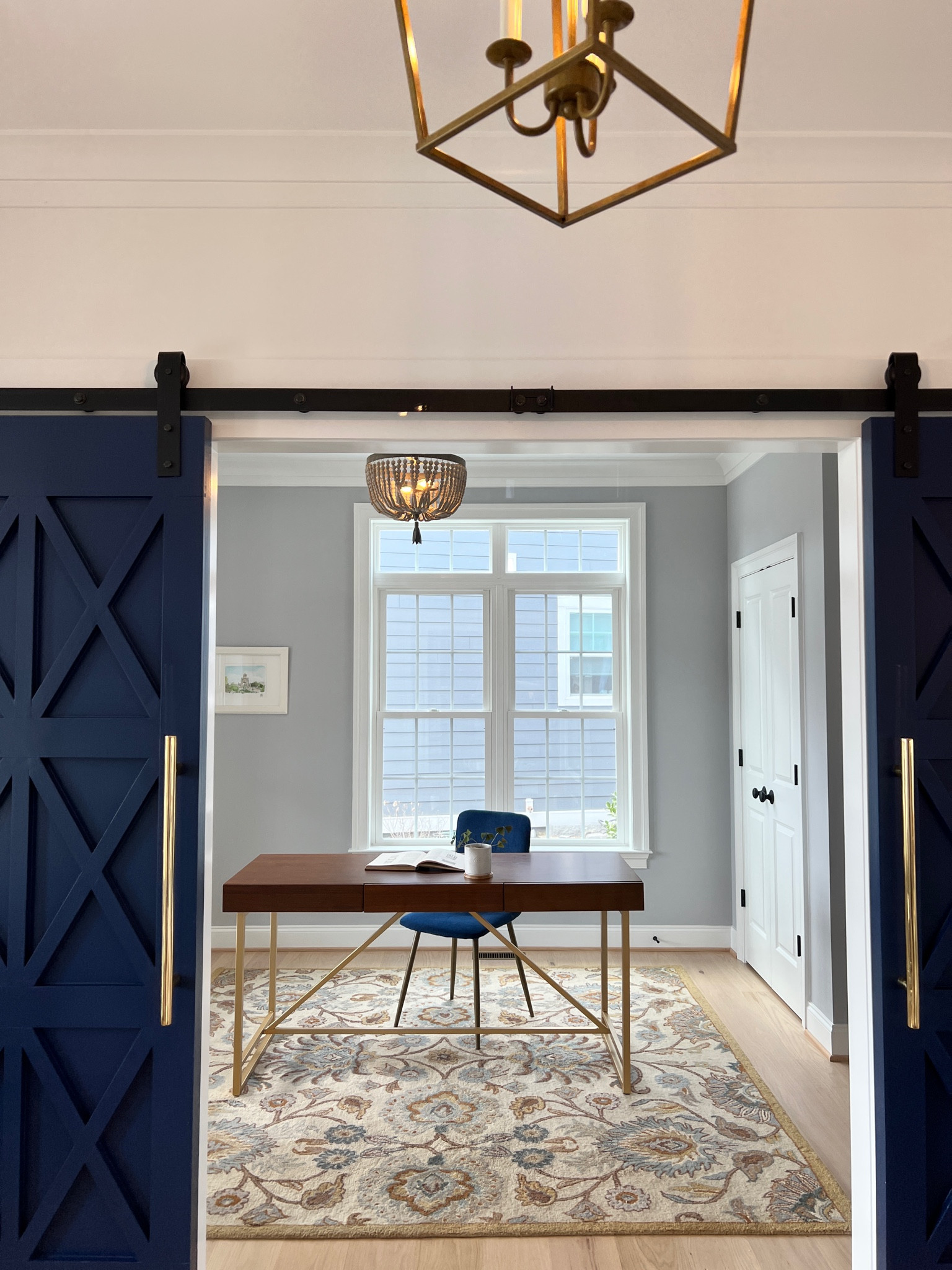 At home office / desk / wood and gold working desk / blue barn doors / door details / chandeliers 

#LTKfamily #LTKSeasonal #LTKhome