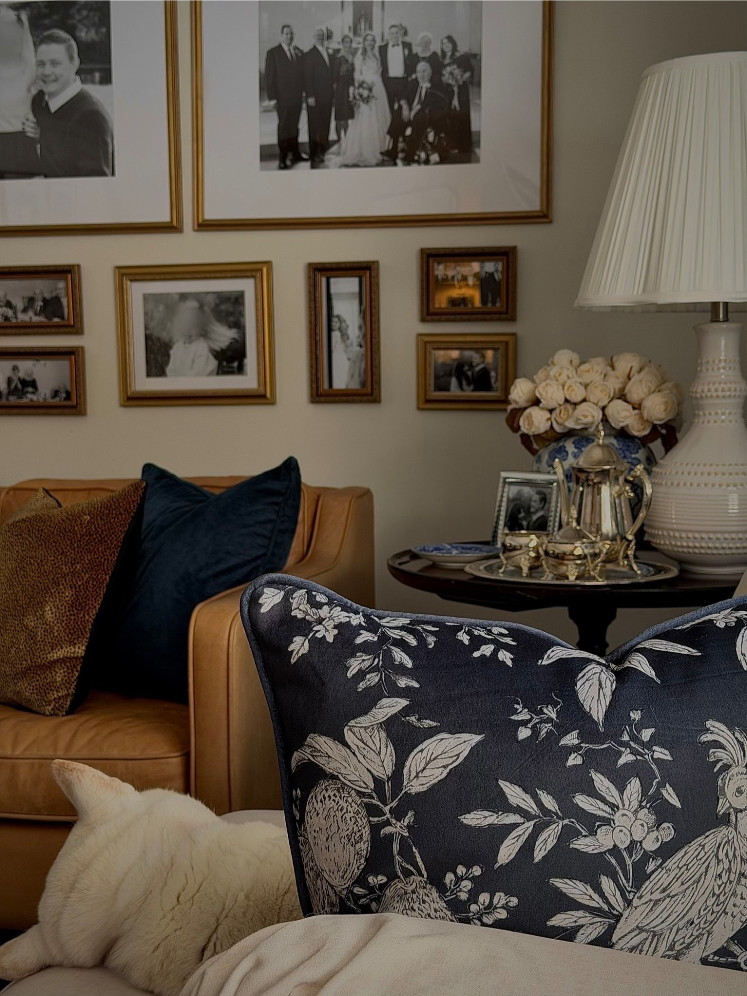 A cozy, Ralph Lauren-inspired living room layered with navy florals, camel leather, silver accents, and a collected gallery of family frames. This space blends classic warmth with personal storytelling for a timeless, elegant look that feels both curated and lived-in.

Save for classic home decor and elevated living inspiration.

#liketkit #LTKHome
#ClassicHomeDecor #TimelessInteriors 
#TraditionalHome #MaeveAndJames

Follow my LTK @Maeve&James on the @shop.LTK app to view this post and shop this look!