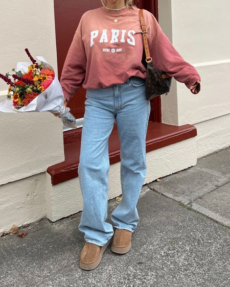 Anine Bing sweatshirt: M tts loose fit
Abercrombie jeans tts I’m between 29 & 30 typically I do a 29 in this style. Long length I’m 5’ 5” but wanted a longer cut! Ugg Tazz run true to size with a snug fit but the fluff inside wears down with each wear. I’m between a 7.5 & 8 and the 8 fits perfectly. Size up if you’re between definitely don’t size down in uggs! 

