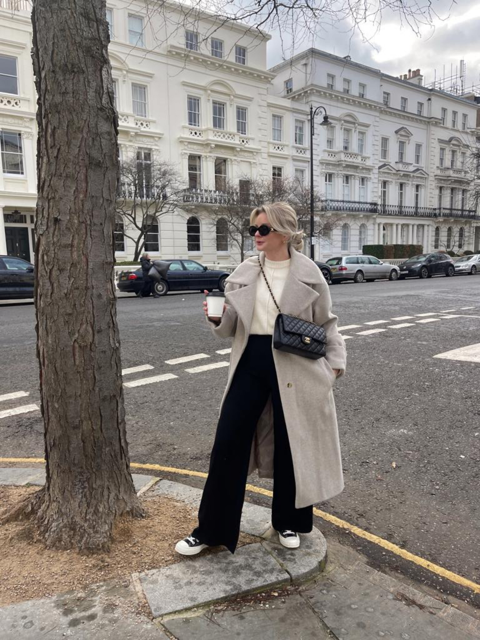 Beige, black & cream classic outfit idea. Beige mango long coat, cream round neck knit jumper, Chanel classic flap handbag, black wide leg trousers and black & white converse. 

#LTKstyletip #LTKshoecrush #LTKeurope