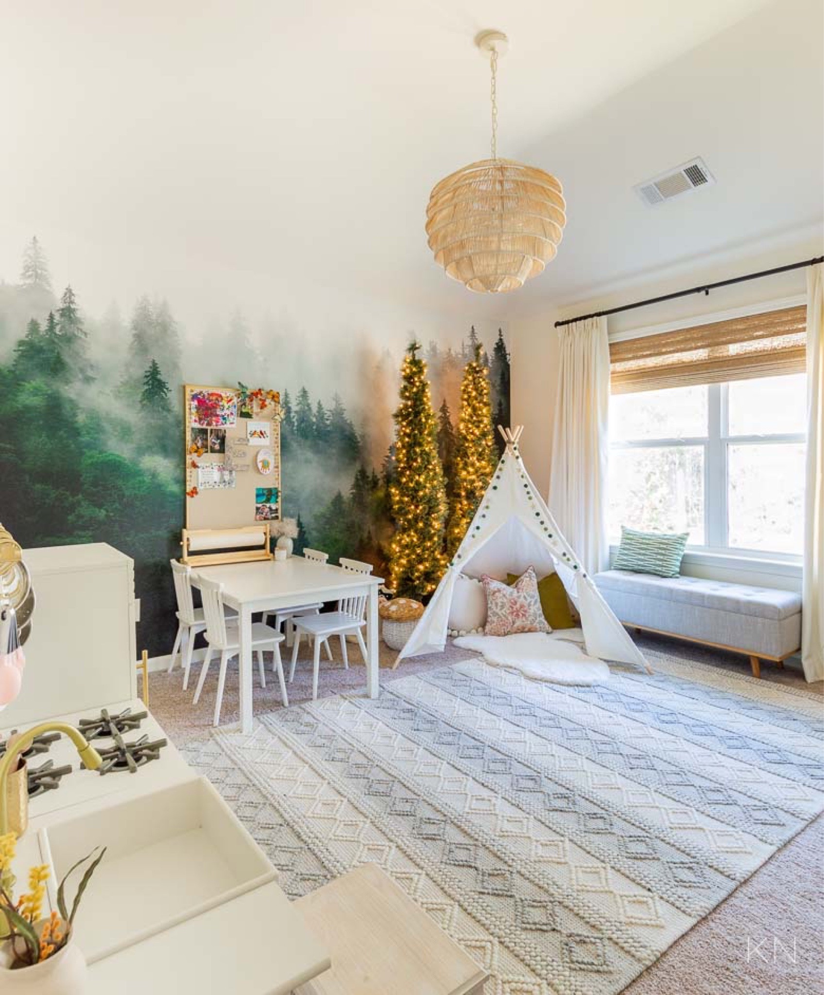 One of my all time favorite (and sweetest!) projects I’ve completed is this forest-inspired playroom. It has an art station, play kitchen, reading nook and tons of storage. The forest mural feature wall is timeless and was so easy to do. home decor playroom decor kid room teepee tent storage bench play table and chairs knotted area rug

#LTKkids #LTKhome #LTKstyletip