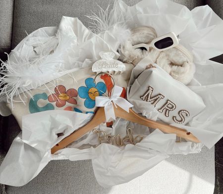 the perfect BRIDE basket 💍💎🤍❕🕊️👰🏼👰🏽‍♀️ everything linked: 
• slippers
• sunglasses 
• bride hanger
• ‘cool wives club’
• ‘just married’ candle 
• bride clip
• white feathered robe 
• MRS. Make up tote

#LTKwedding #LTKSeasonal #LTKFind
