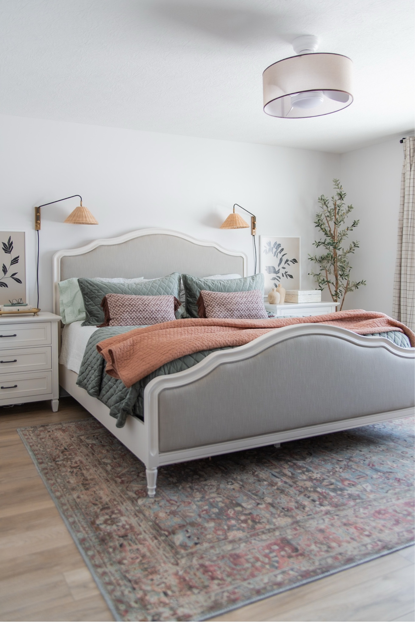 Spring bedroom decor, wicker rattan wall sconces, teal velvet quilt, wood frame upholstered bed, antique white nightstands, best faux olive tree, teal and terracotta vintage look printed rug

#LTKSeasonal #LTKHome #LTKMostLoved