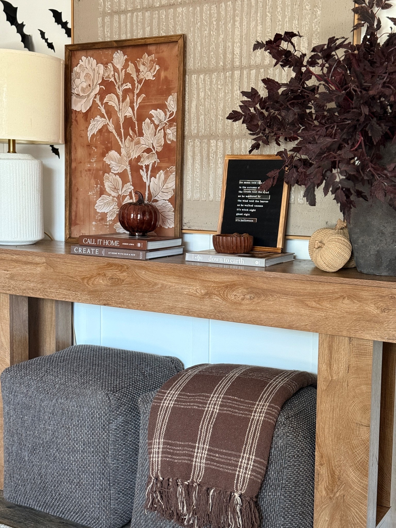 Falloween console styling!
Look for less wood console table, brown ottomans, brown plaid throw, plum stems, fall canvas art

#LTKSeasonal #LTKHalloween #LTKHome