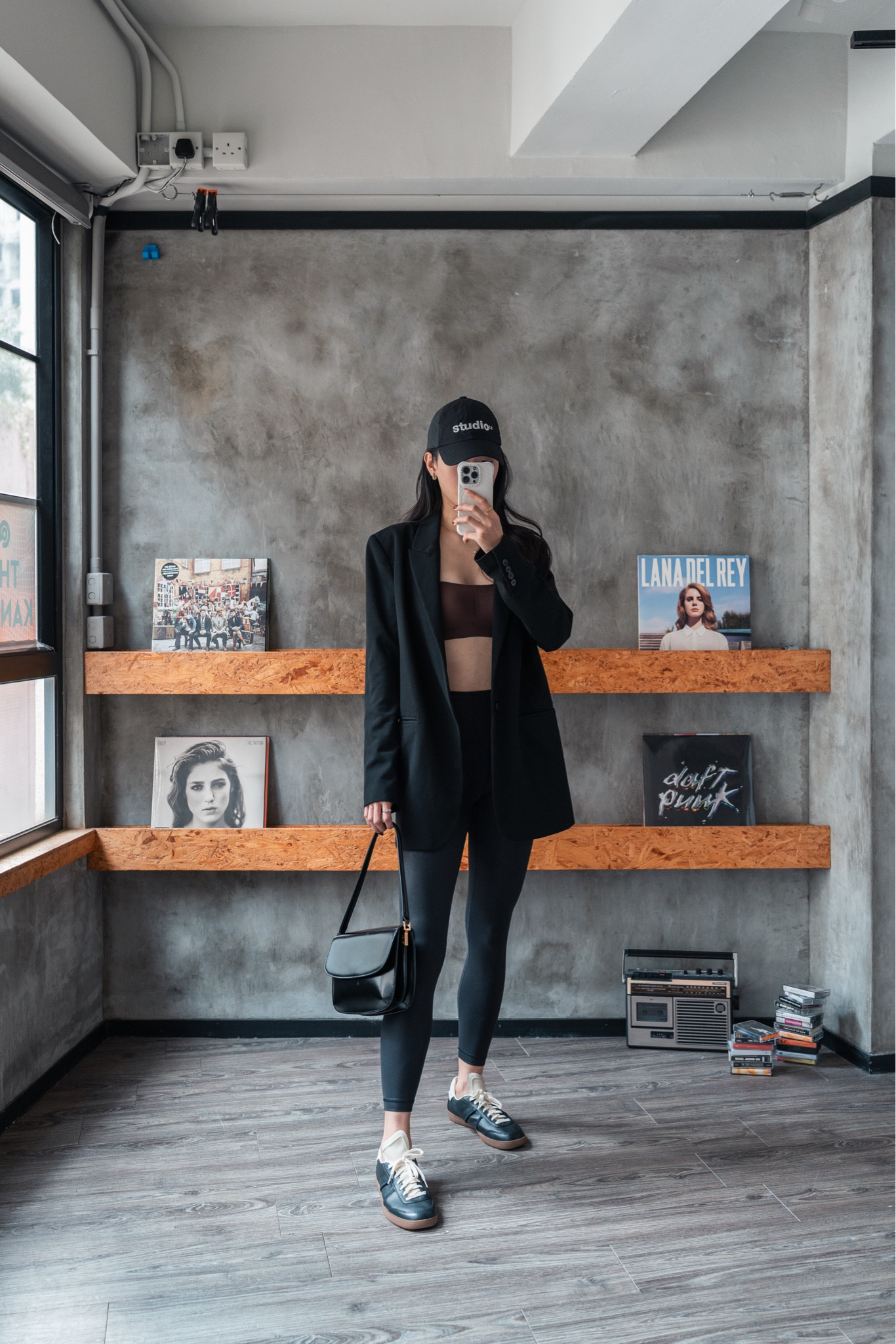 Chic urban outfit — graphic cap, black blazer, brown bralette, shine leggings, box leather handbag, sneakers

#LTKwinter #LTKstyletip #LTKdatenight
