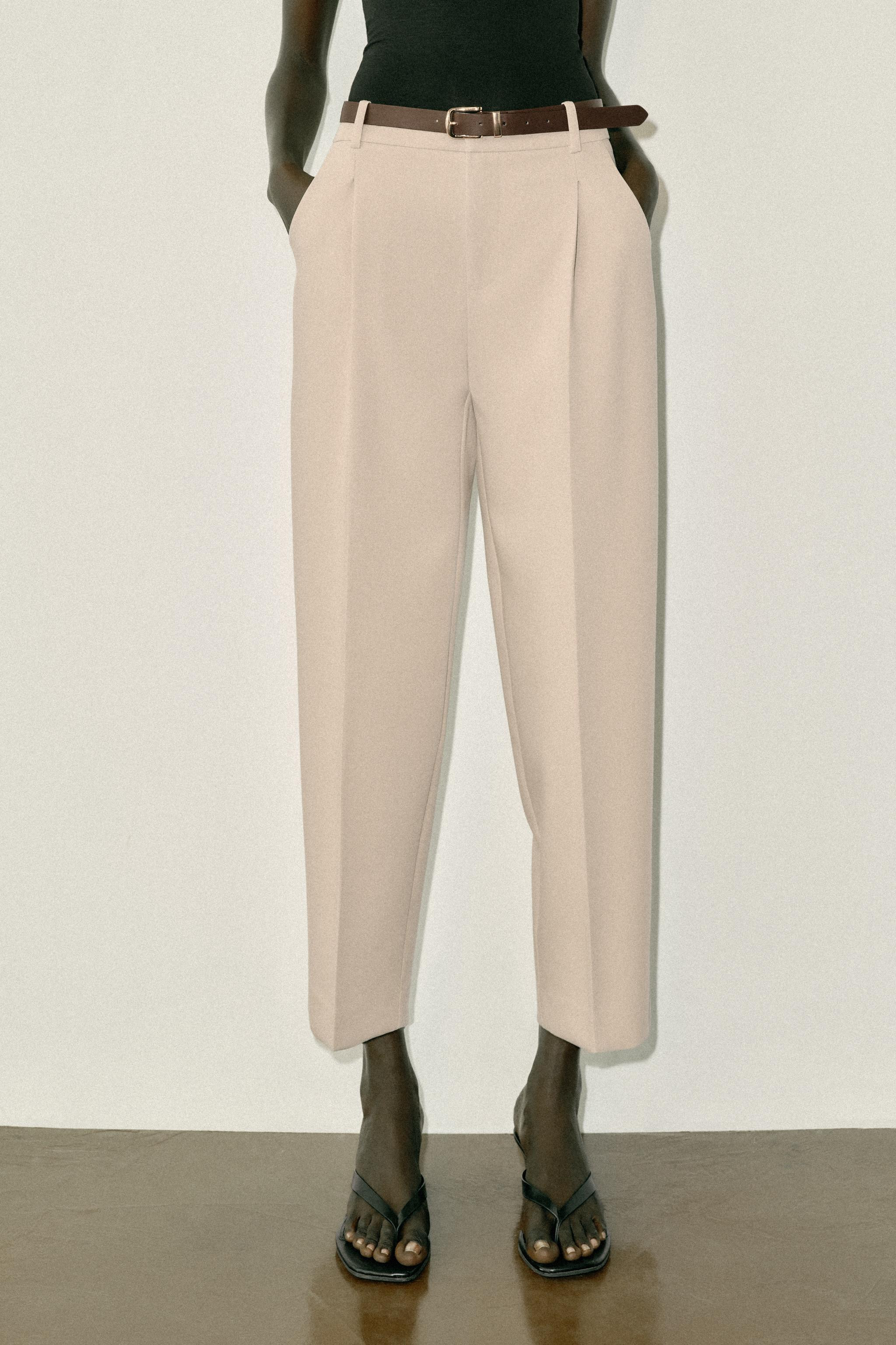 Mid-waist cropped trousers with a belt and front pleats. Featuring front pockets and false flap b... | Zara UK
