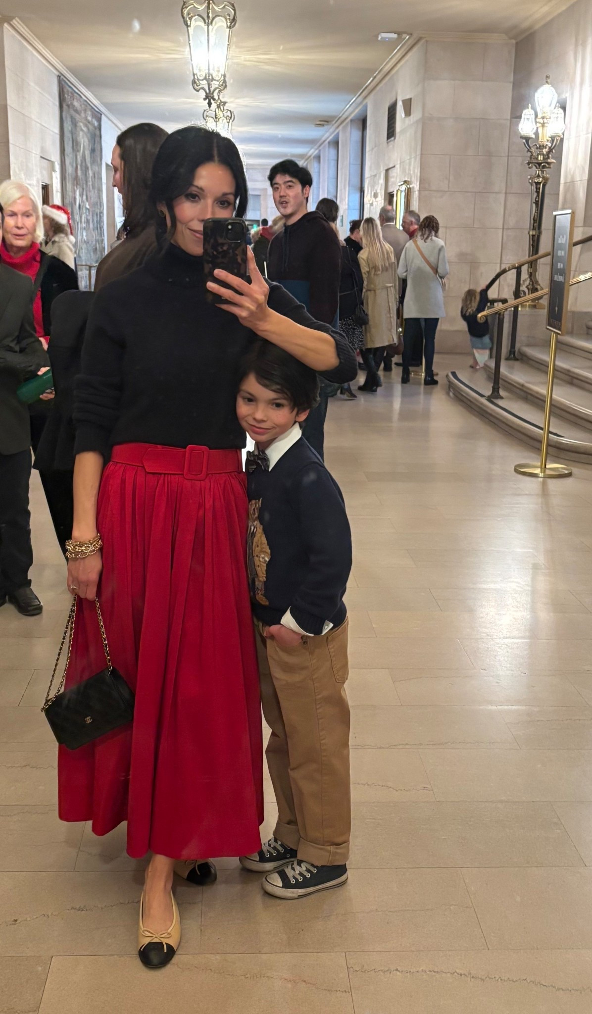 Red ball skirt, (linking similar), classic black turtleneck sweater, tuck band (amazing for hiding bulky sweaters when tucking into skirts or jeans), Chanel bag, Chanel cap toe ballet flats. 

My sons sweater is Ralph Lauren (linking a similar boys cotton Ralph Lauren bear sweater since his is sold out), jeans are Target, sneakers are Converse Chuck Taylor, and plaid bow tie is from Amazon  

#LTKSeasonal #LTKOver40 #LTKHoliday