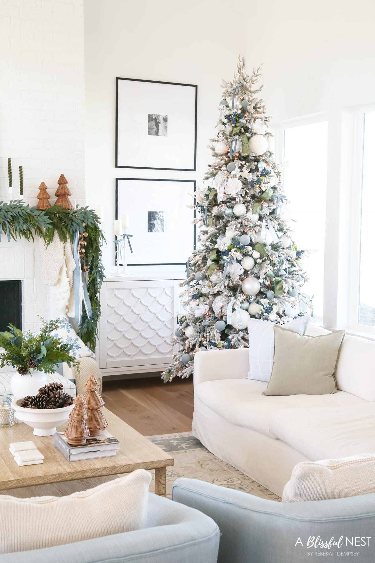 Holiday styling can be simple and beautiful. Tap to grab the pieces I used.
knit Christmas stockings, Norfolk pine Christmas garland, dusty blue satin ribbon, ivory velvet ribbon, vintage cluster cow bells on rope, upholstered cube ottoman, fairy lights, blue berry greenery picks, cream textured throw pillow, baby blue matte Christmas ornaments, velvet Christmas balls, moss green velvet ribbon, dusty blue 2 inch wide satin ribbon, Natural Pine Cones, scented candles 

 #LTKHoliday #LTKSeasonal #LTKHome