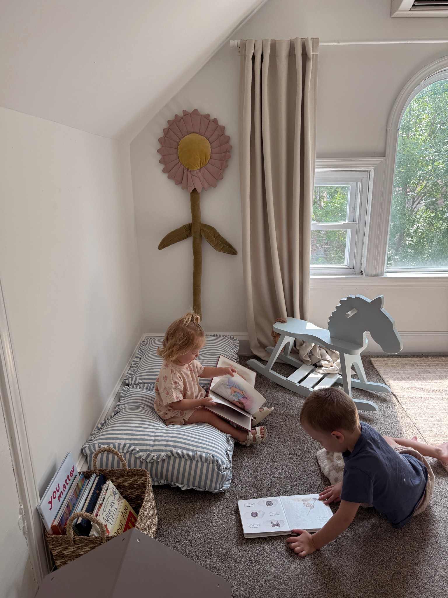 The cutest blue stripe reading corner floor pillows for toddler girl room!