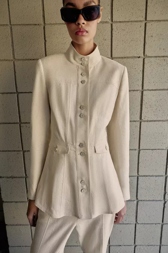 Fitted jacket made with linen. High collar and long sleeves with shoulder pads. Front flap pocket... | Zara US
