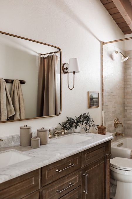 Shop our neutral bathroom with wood vanity! Love this oversized mirror and affordable bathroom sconces. The shower curtain is the ‘brown’ option! 

#LTKSeasonal #LTKhome #LTKsalealert