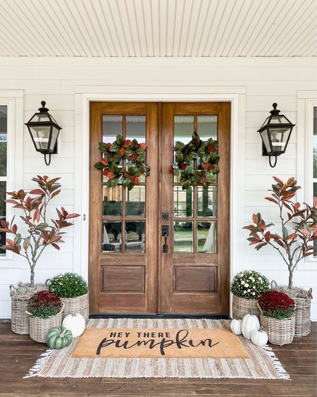 Front porch and door decor fall autumn harvest seasonal entry French double doors oversized layered scatter rug and doormat pumpkin magnolia trees faux artificial silk florals mums baskets wreaths outdoor lanterns wall sconces rocking chairs light fixtures southern modern farmhouse style home decor nearly natural amazon finds Etsy wayfair marshalls TJ Maxx home goods Walmart autumn oak trees 

#LTKhome #LTKSeasonal #LTKHalloween
