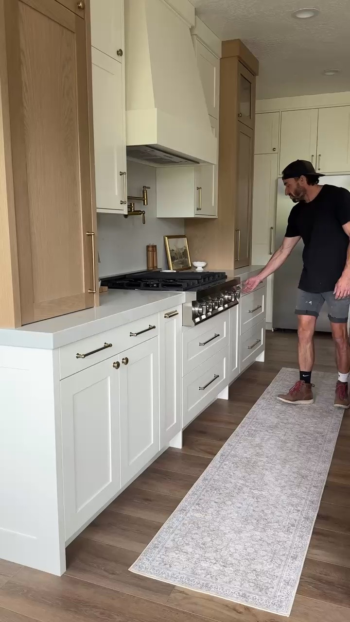 Want a white kitchen that still feels warm? Look at the wood cabinetry beside the range 🤎 Adam built the cabinetry in this client’s home. For your own version, I’ve linked brass hardware and a pot-filler alternative, plus a pendant I’d consider to carry that warmth over an island. These are suggested shopping options, not confirmed exact products from this kitchen. Check sizes and installation requirements for your space, then shop the tagged picks

#LTKHome