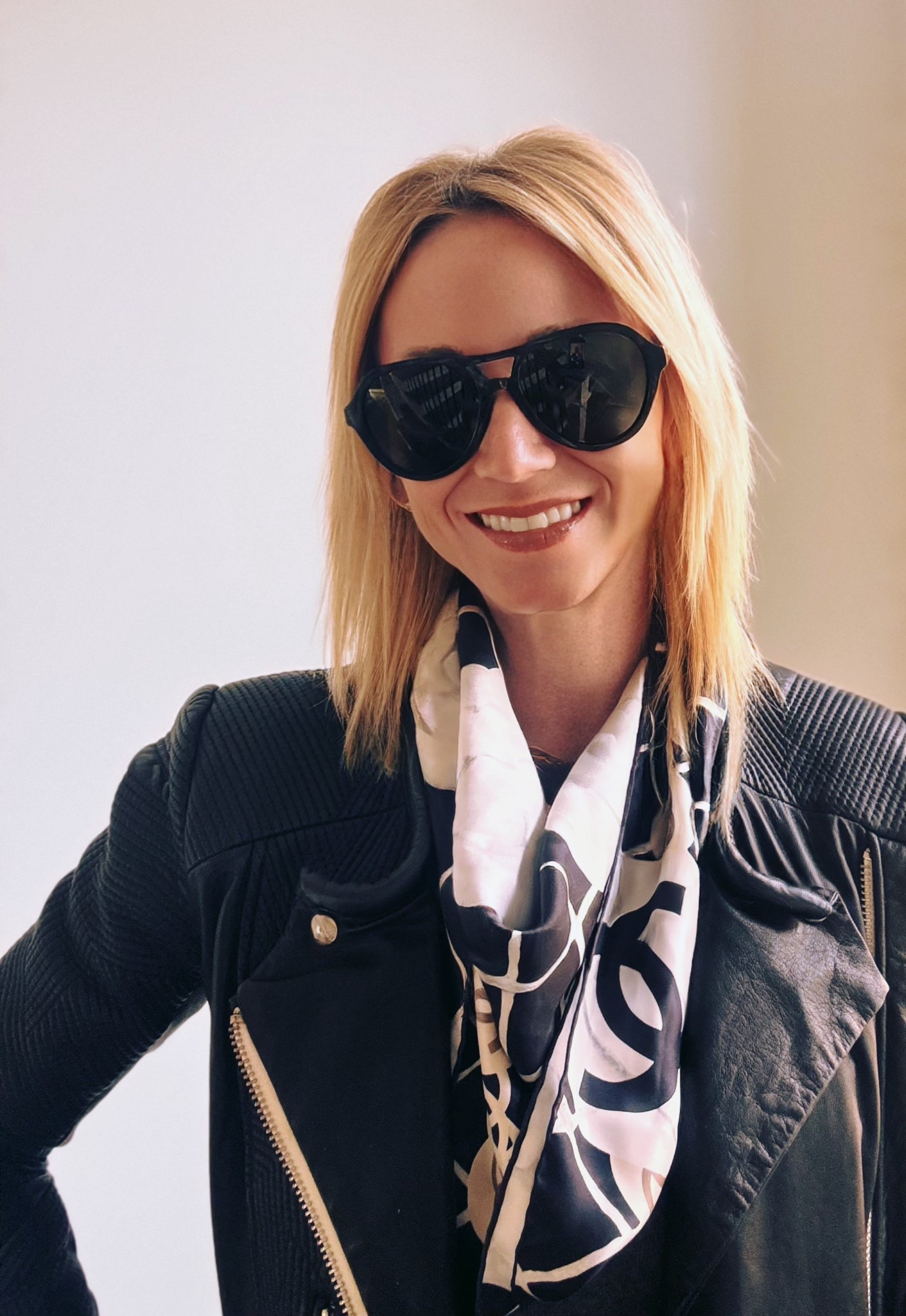 Let’s be honest, we barely have time to pick out an outfit in the morning, let alone figure out how to incorporate this scarf trend! 
Don’t worry! The idea behind the scarf is to look like you just “threw it on” (even if you didn’t)!
Showing you three ways to style a scarf with a leather jacket and cashmere sweater, but you can easily swap out the jacket for a blazer or trench! I just happen to like this Camilla floral print scarf balanced with a structured leather jacket.
▪️Around the neck: the most obvious and easiest to pull off! Depending on the length of the scarf, you can loop it twice and tie or just once in the back. Honestly, the less symmetrical the better!
▪️Off the shoulder: I love this for a lunch/dinner or event. It’s realistically difficult to keep in place for everyday movement, but when intentionally worn for a “look”, it makes a statement.
▪️Around the waist: this trend started last summer and is sti going strong! It adds a layer and interest to any outfit! Roll the scarf so it has less fabric and wears more like a longer belt than a skirt (we don’t want that!).
Finish off your look with an oversized pair of aviators! 😎

#LTKootd #LTKSeasonal