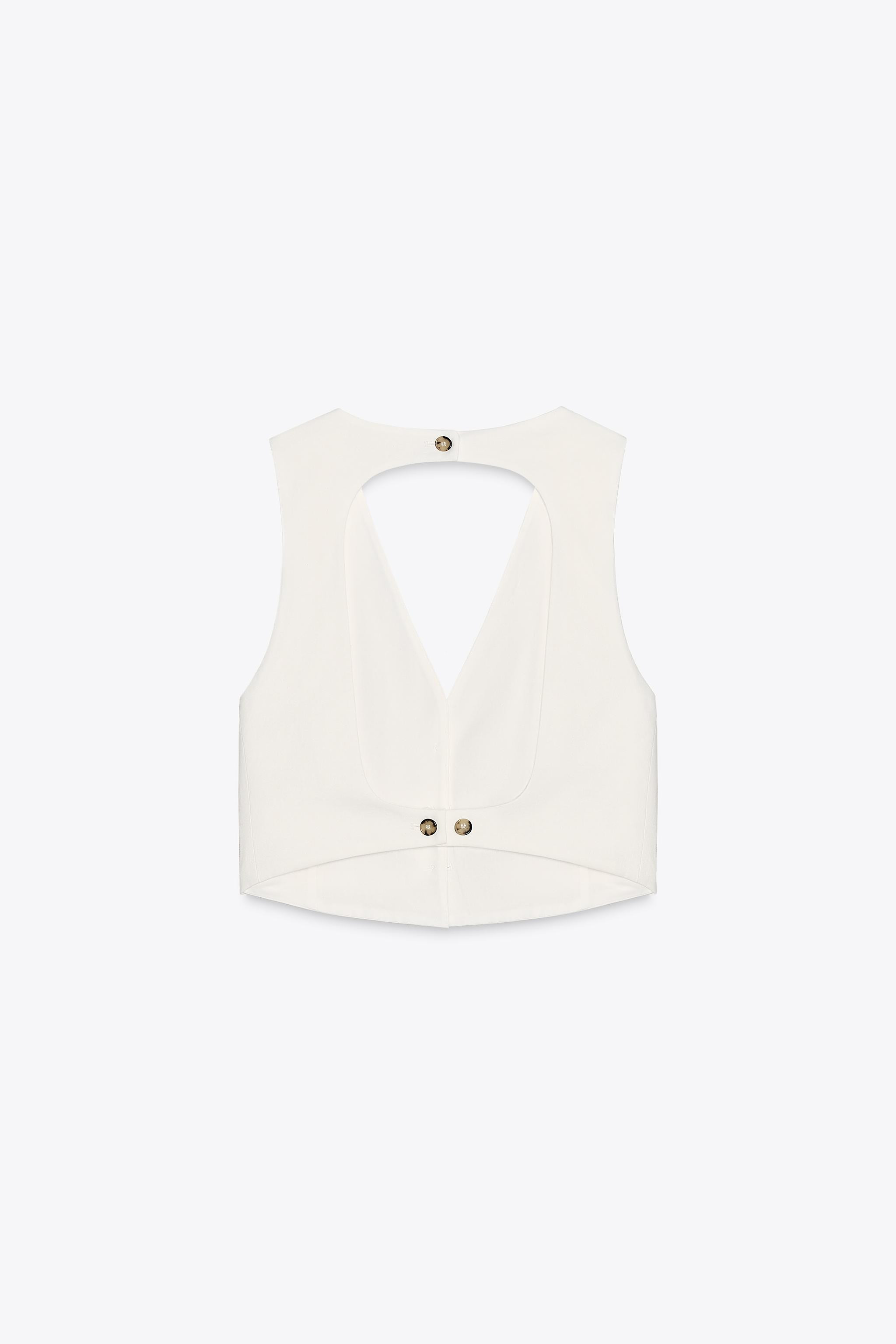 Vest made with 22% linen. V-neck and sleeveless. Open back detail with buttons. Front button clos... | Zara US
