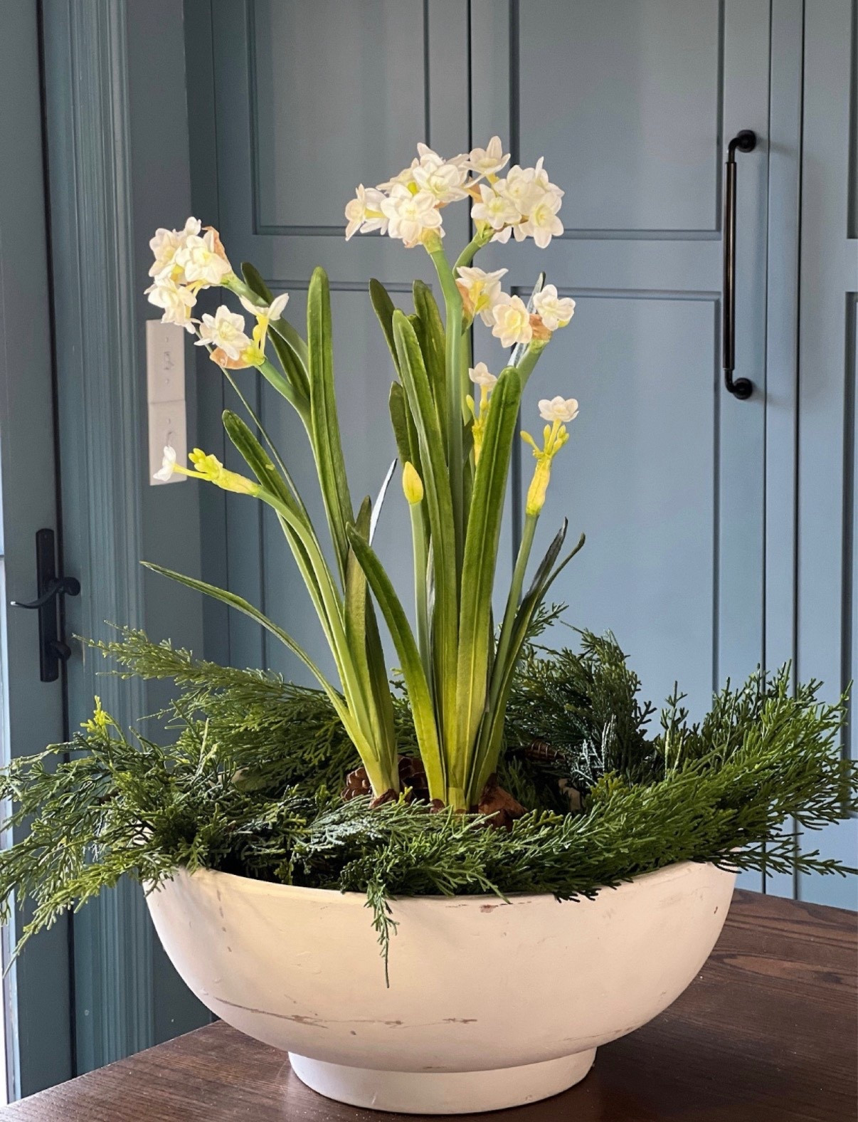 A simple winter centerpiece that will work well in to the spring! 

White large decorative bowl, moss, pinecones, garland and artificial paperwhite bulbs and flowers.


#LTKhome #LTKfindsunder50 #LTKfindsunder100