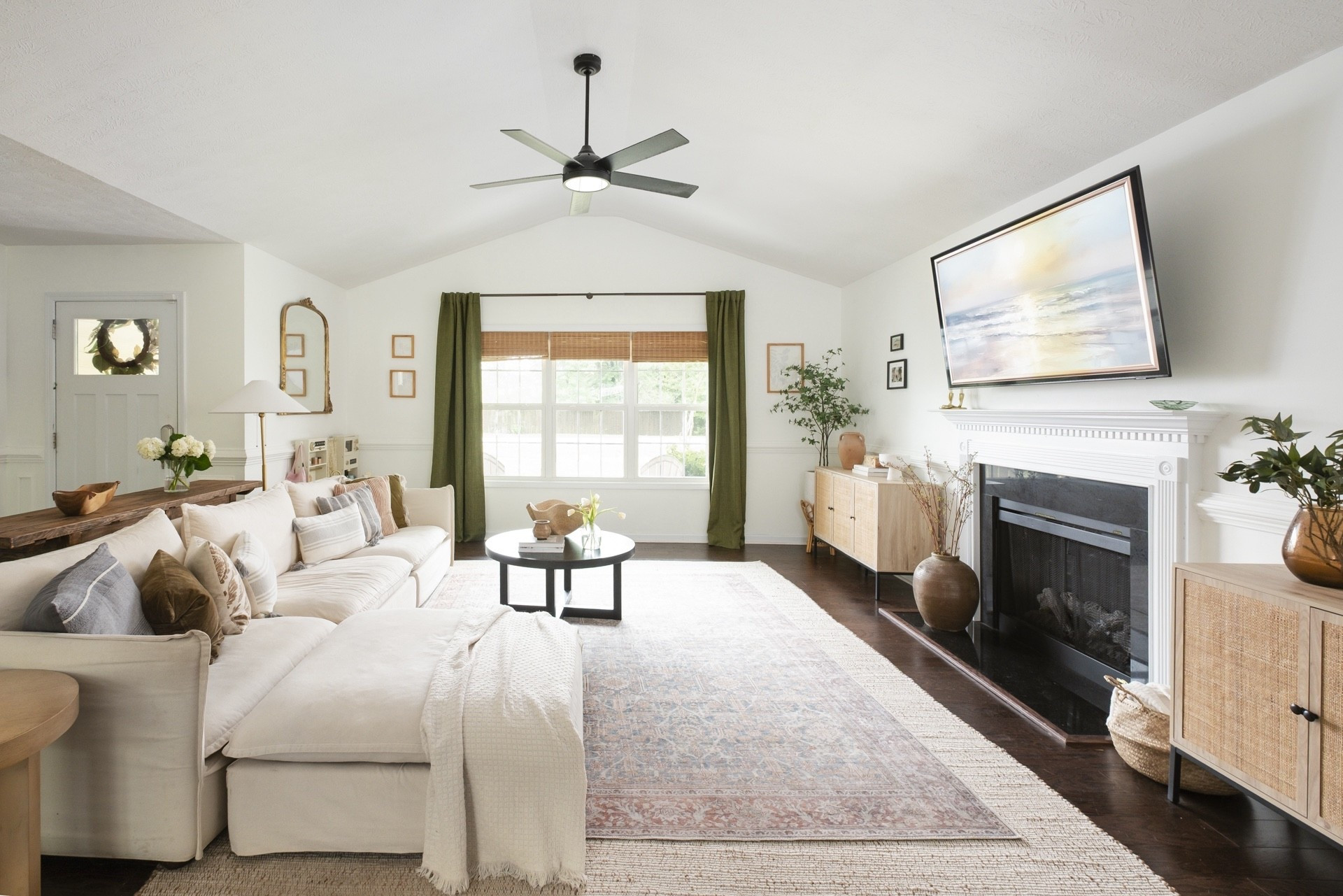 cozy natural living room with a modern touch. we literally sink into our couch while binging shows and nope, that builder grade fireplace has NOT been used. I hope the next owner rips it out or restyles it. 😂