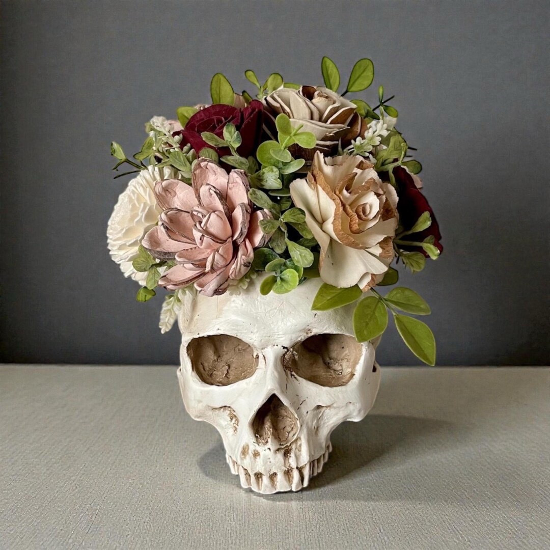 This bold 7” skull planter arrangement from TinyHouseDecor adds a unique twist to classic florals. The decorative skull is topped with a band and filled with beautifully hand-painted sola wood flowers, each carefully dyed and arranged for a one-of-a-kind piece. Made from natural tapioca root, these long-lasting blooms bring edgy charm and artistic texture to shelves, desks, or seasonal décor. 💀🌸 #ltkhome #ltkfinds #etsyfinds #uniquehome #gothdecor #handmadedecor

#LTKSeasonal #LTKHome