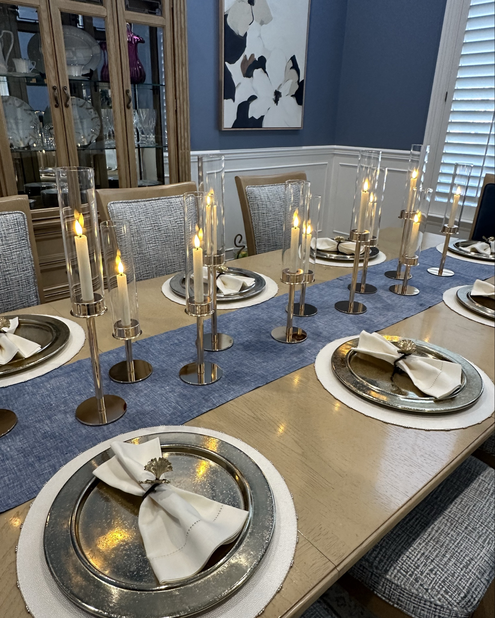 Blue and Cream Table Decor. These candle hurricanes are perfect for the holidays. 
#candles #candleholders #tampercandles #batterycandles #goldplatechargers #linentablerunner #linennapkins #amazon #amazonhome #potterybarn #tabledecor 

#LTKCyberWeek #LTKHome #LTKHoliday