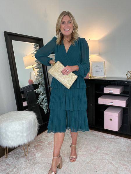 Emerald green tiered dress. Wrap bodice. Fully lined. Soft pleats. Runs large . Size down one. Under $60. Linking similar options too. Gold clutch. Gold metallic heels. 

#LTKworkwear #LTKparties #LTKover40