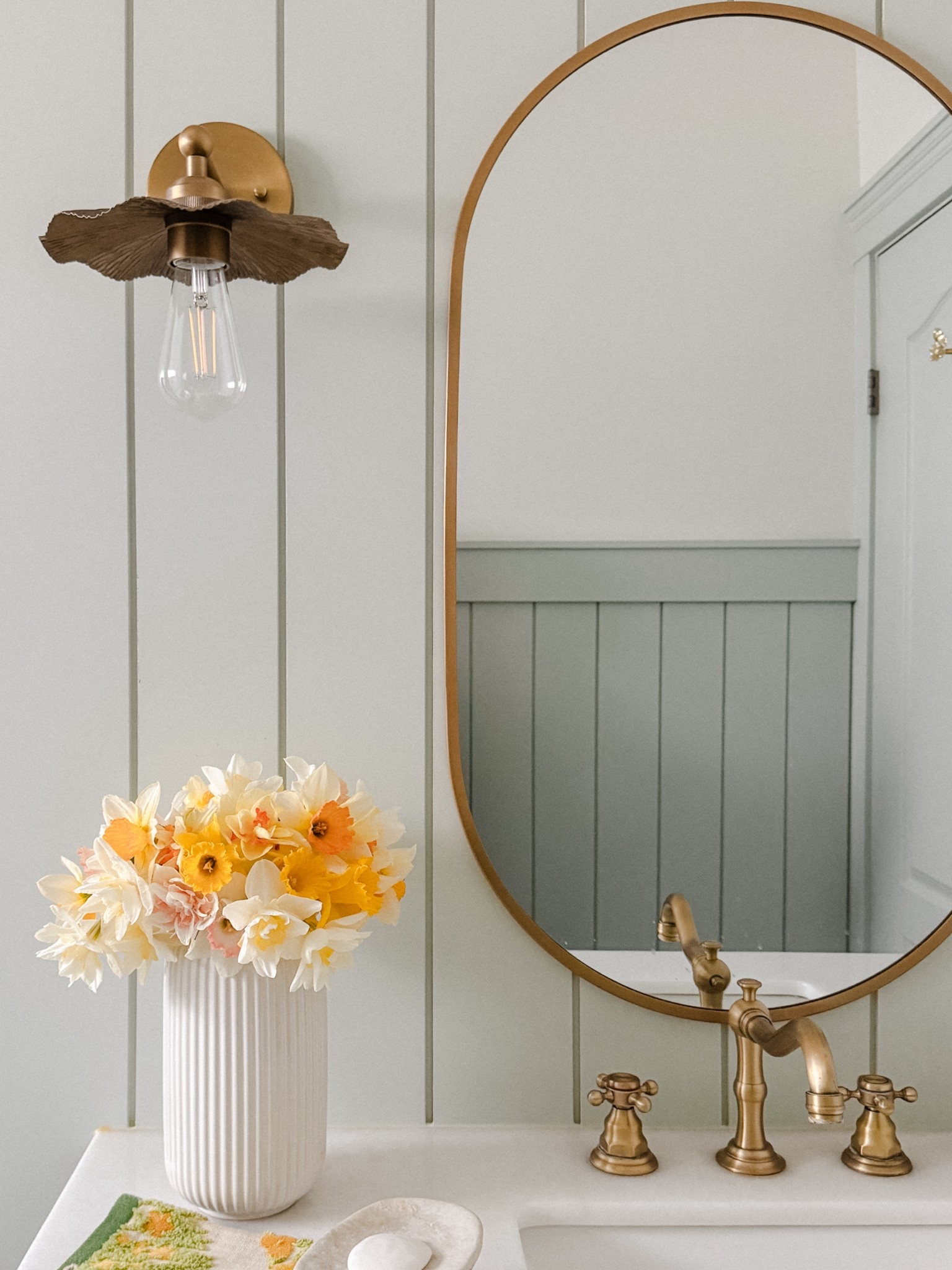 Brass pill mirror, floral flower sconces, gold faucet

#LTKHome