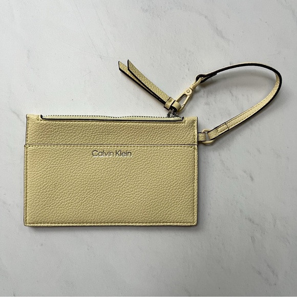 [calvin klein] pebbled faux leather zip wristlet pouch light yellow | Poshmark